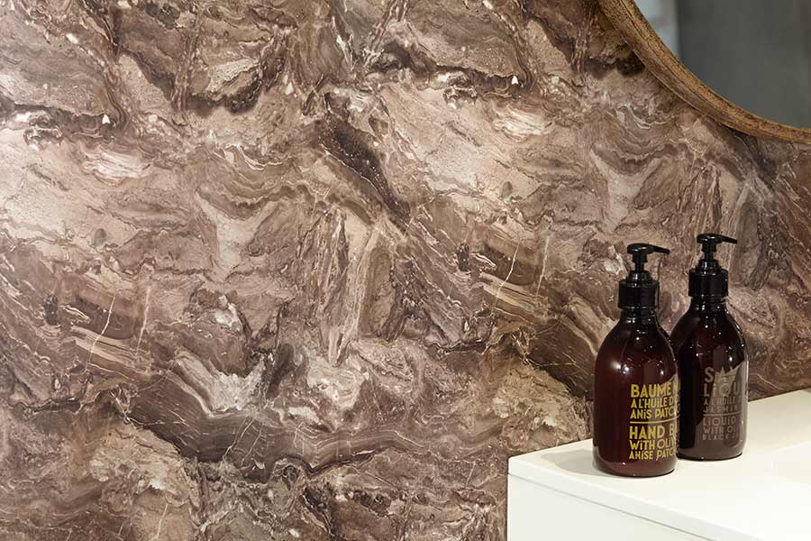 Bushboard stone effect bathroom splashback in Terracotta
